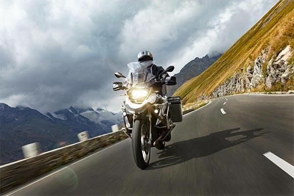 homem andando de moto pelas montanhas